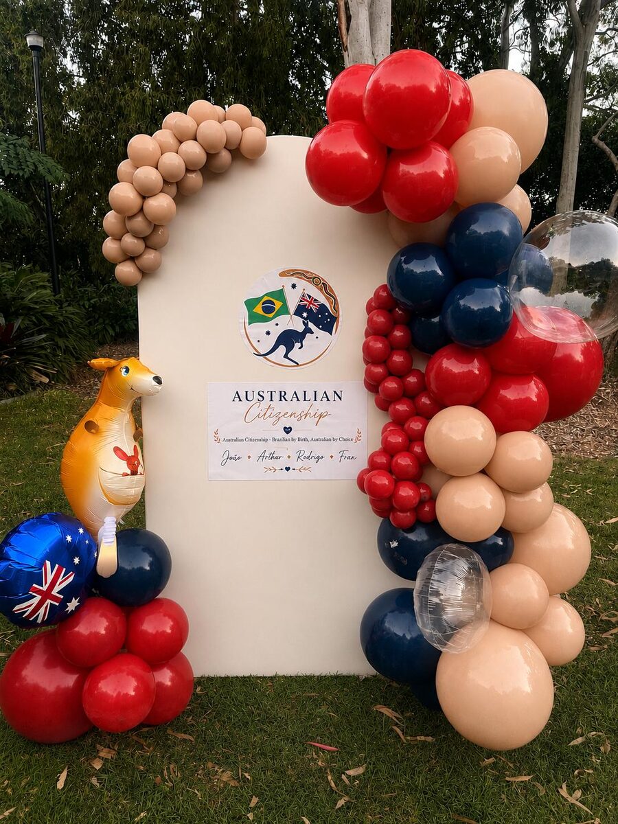 Australian citizenship celebration with red, navy and sand organic arch